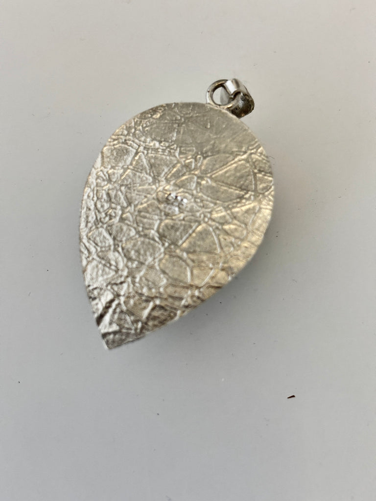 Back of handmade Peruvian Opal pendant with water inspired sterling silver texture