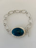 Oval Peruvian Opal bracelet with hand textured radiating silver border