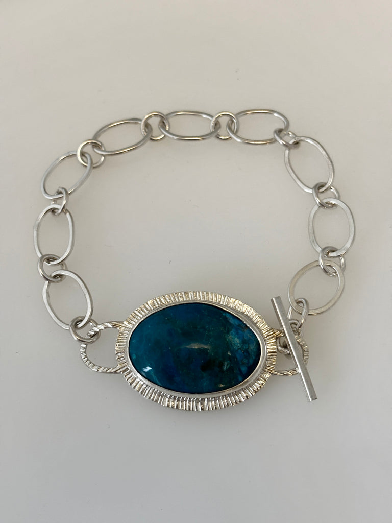 Oval Peruvian Opal bracelet with hand textured radiating silver border