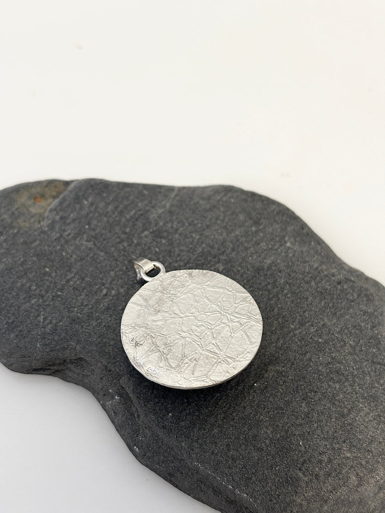 Back of round Peruvian Opal silver pendant with water inspired textured sterling silver
