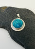 Vibrant blue round Peruvian Opal sterling silver pendant with radiating textured border